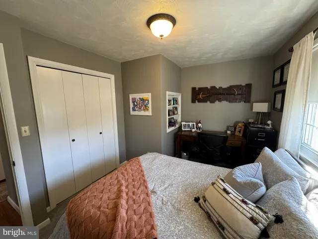 a bedroom with a bed window and a couch