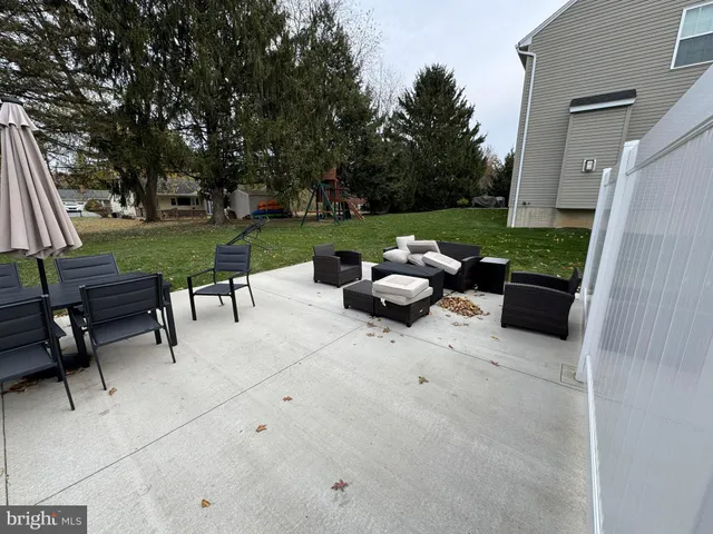 a view of a patio with couches and a table and chairs with garden