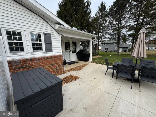 a view of a house with backyard and sitting area