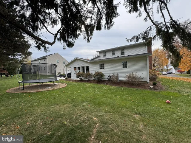 a view of house with backyard