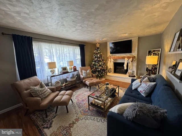 a living room with furniture fireplace and a flat screen tv
