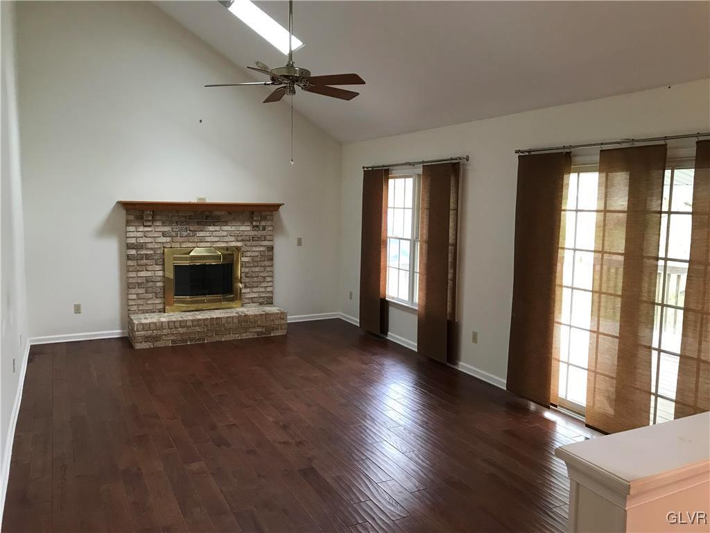 10 Frys Run Road Easton, PA 18042 - Photo 8 of 44 an empty room with wooden floor fireplace and windows