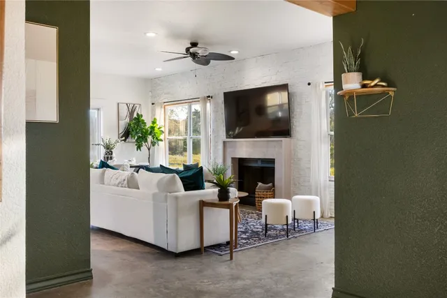 a living room with furniture a fireplace and a flat screen tv
