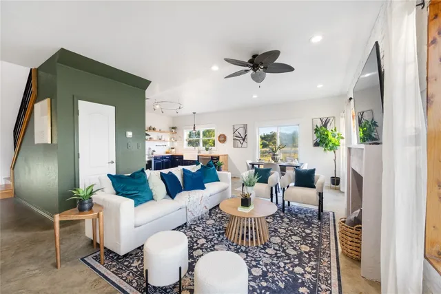 a living room with furniture and a chandelier