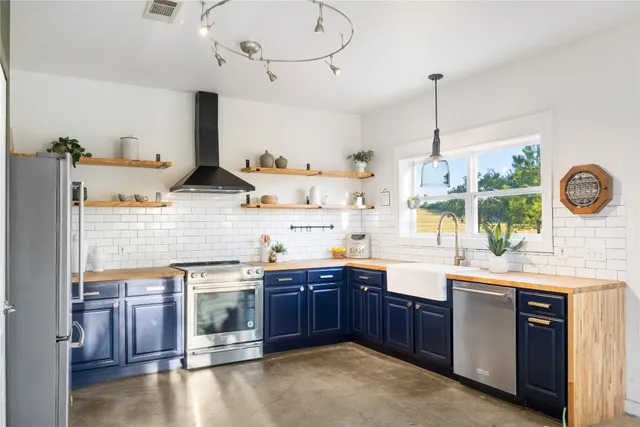 a kitchen with a sink a stove and cabinets