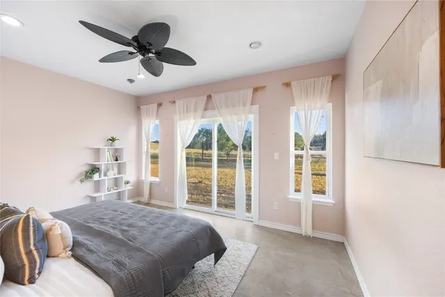 a spacious bedroom with a large bed and a large window