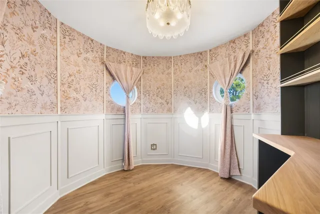 a view of a hallway with entryway and chandelier