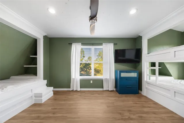 a bedroom with a bed and a television