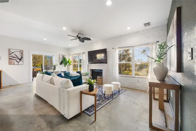 a living room with furniture a fireplace and a flat screen tv