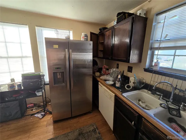 a kitchen with stainless steel appliances granite countertop a refrigerator and a sink