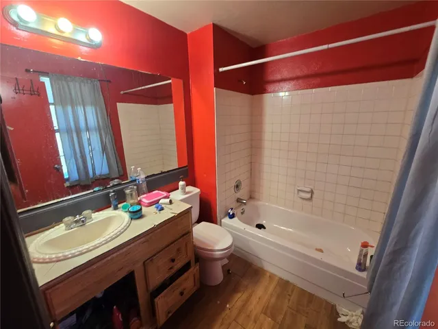 a bathroom with a sink vanity mirror and toilet