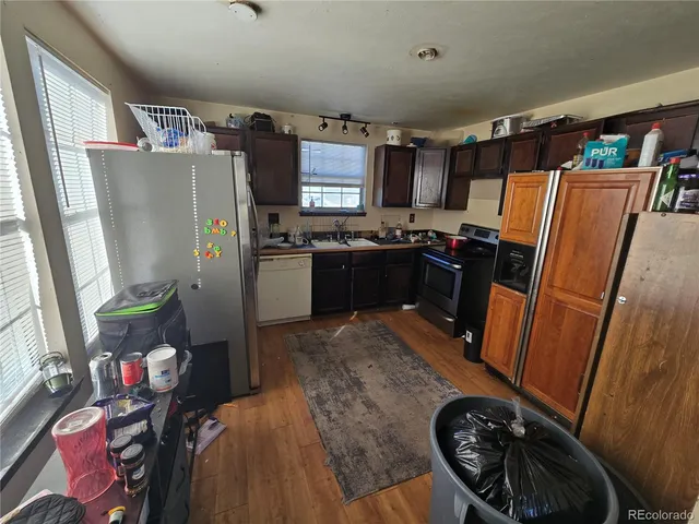 a kitchen with stainless steel appliances granite countertop a refrigerator and a stove