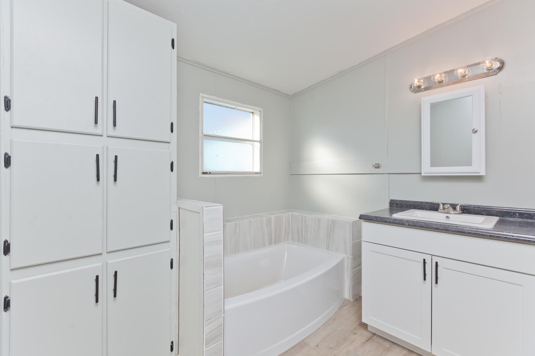 3066 Cardinal Court Grand Junction, CO 81504 - Photo 20 of 41 a bathroom with a tub sink and mirror