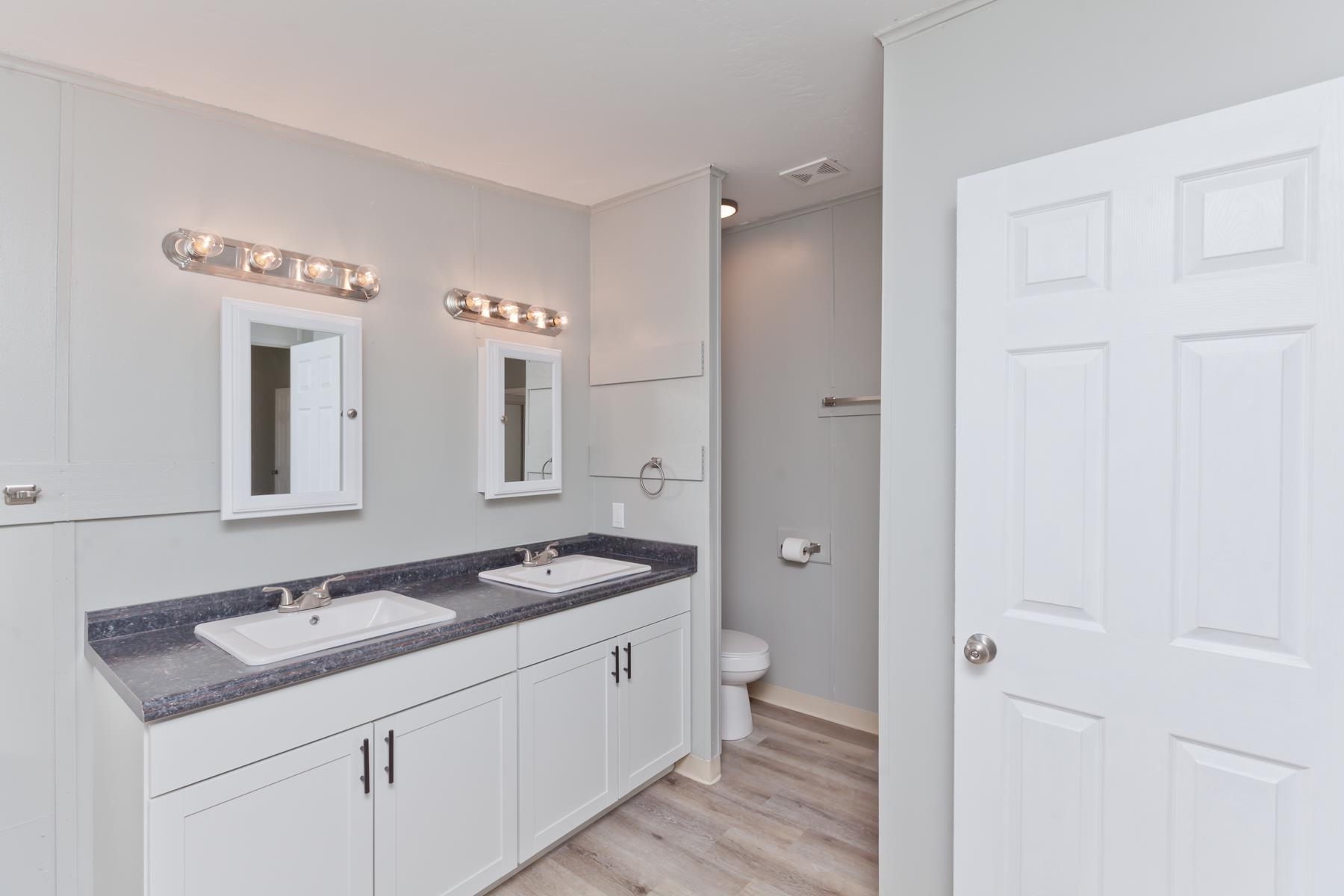 3066 Cardinal Court Grand Junction, CO 81504 - Photo 21 of 41 a spacious bathroom with a granite countertop sink and a mirror