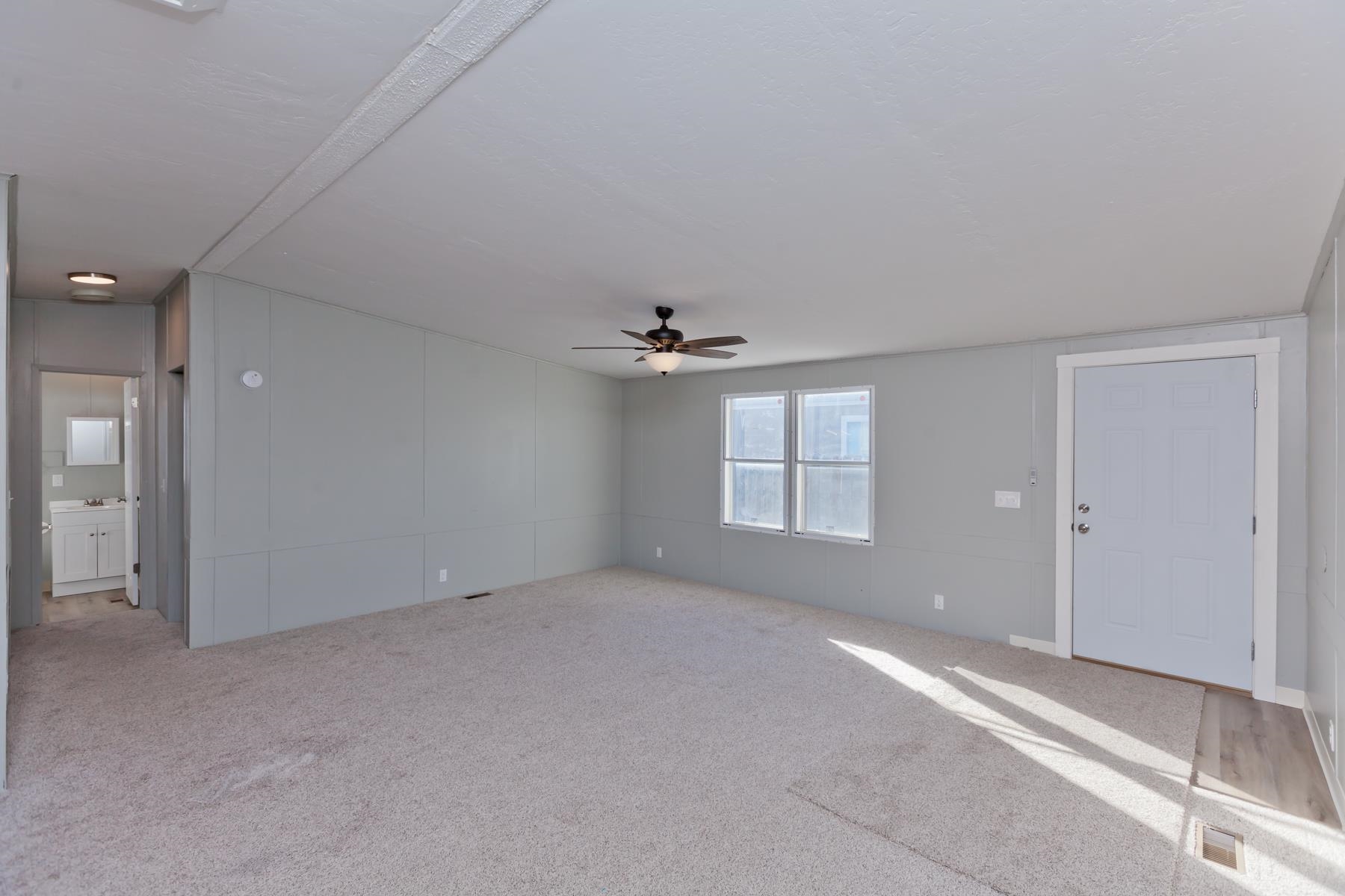 3066 Cardinal Court Grand Junction, CO 81504 - Photo 4 of 41 an empty room with windows and fan