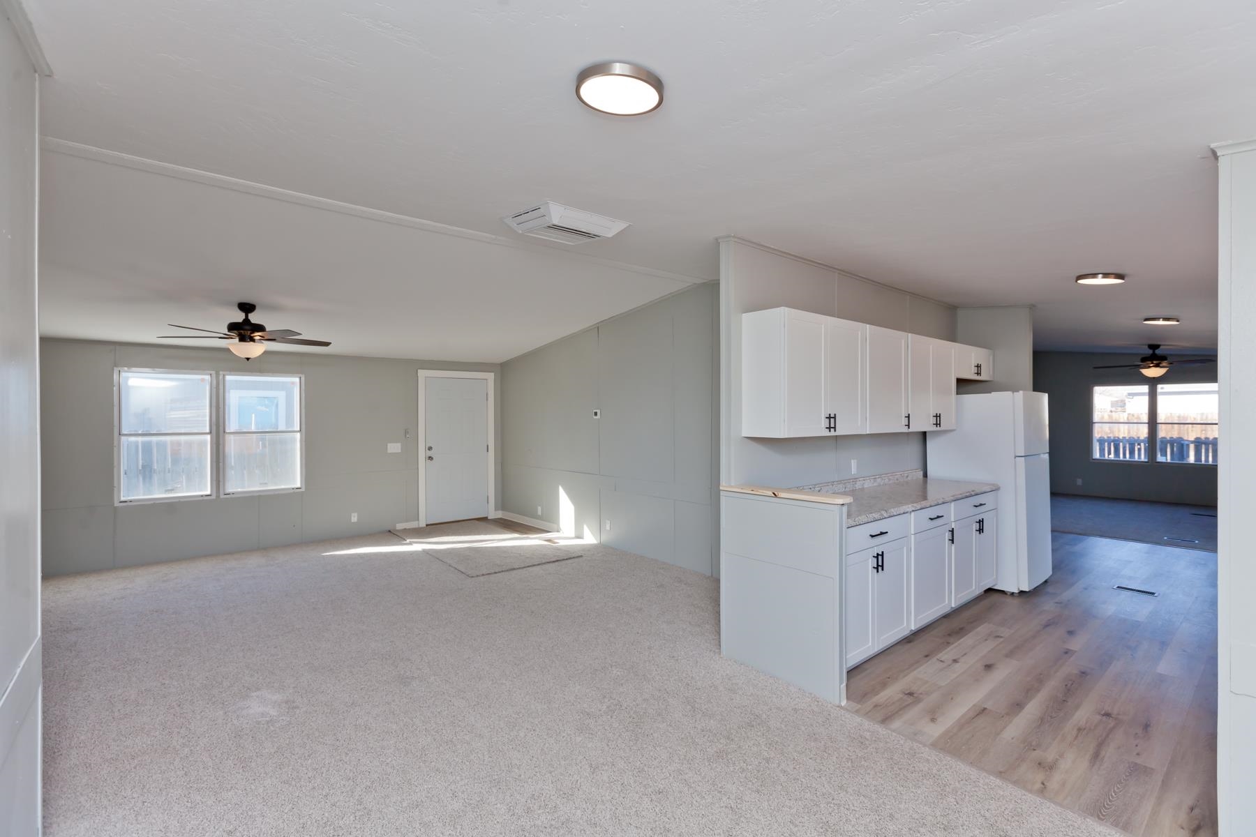 3066 Cardinal Court Grand Junction, CO 81504 - Photo 6 of 41 a view of an empty room with window and wooden floor