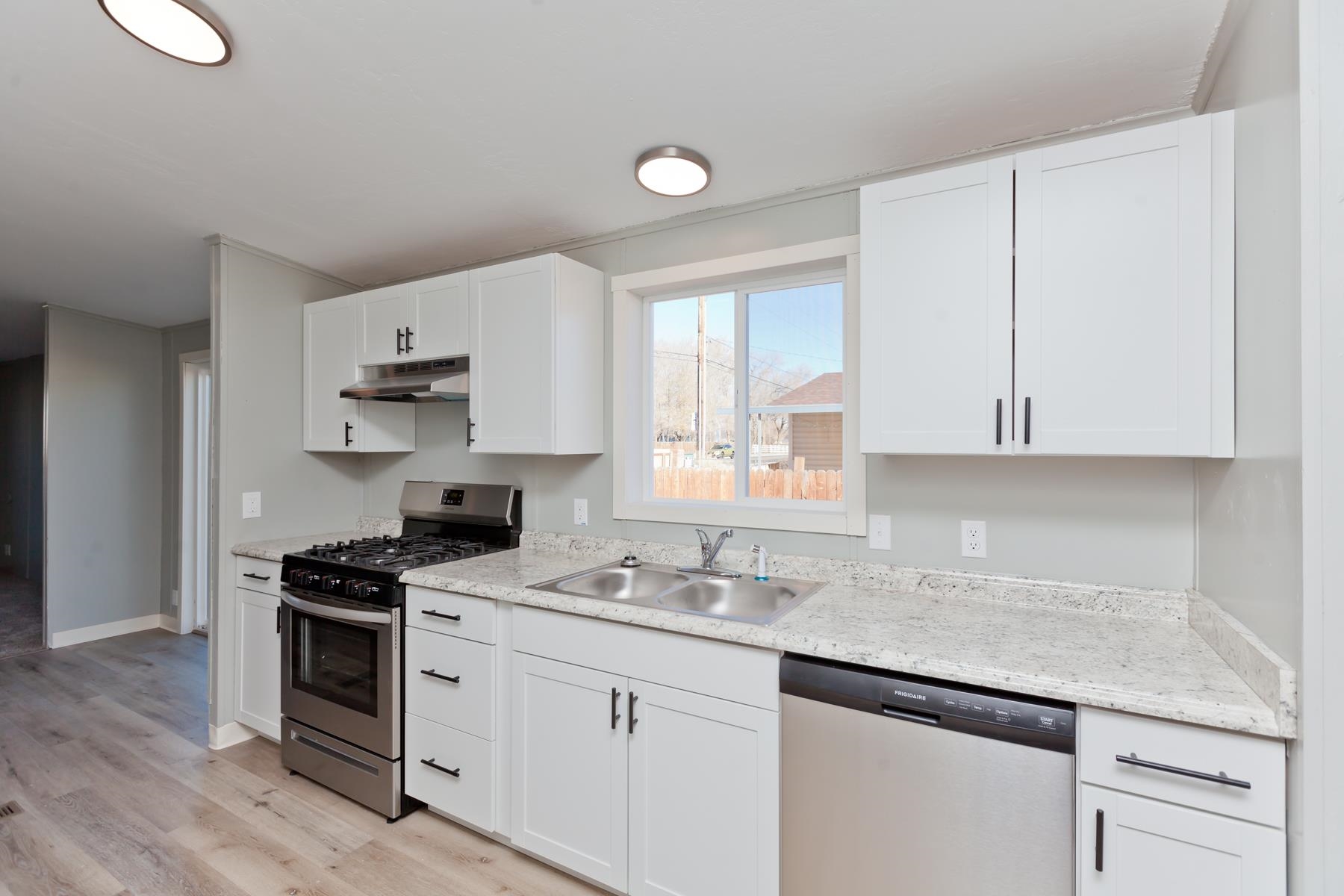 3066 Cardinal Court Grand Junction, CO 81504 - Photo 7 of 41 a kitchen with cabinets appliances a sink and a counter space