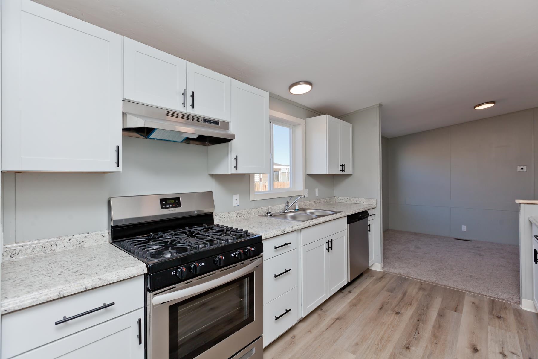 3066 Cardinal Court Grand Junction, CO 81504 - Photo 8 of 41 a kitchen with stainless steel appliances white cabinets and a stove top oven