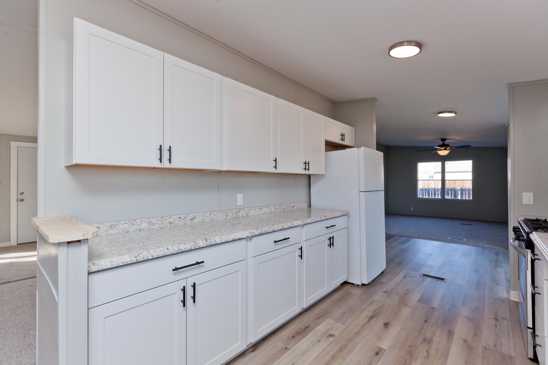 3066 Cardinal Court Grand Junction, CO 81504 - Photo 9 of 41 a kitchen with sink cabinets and wooden floor