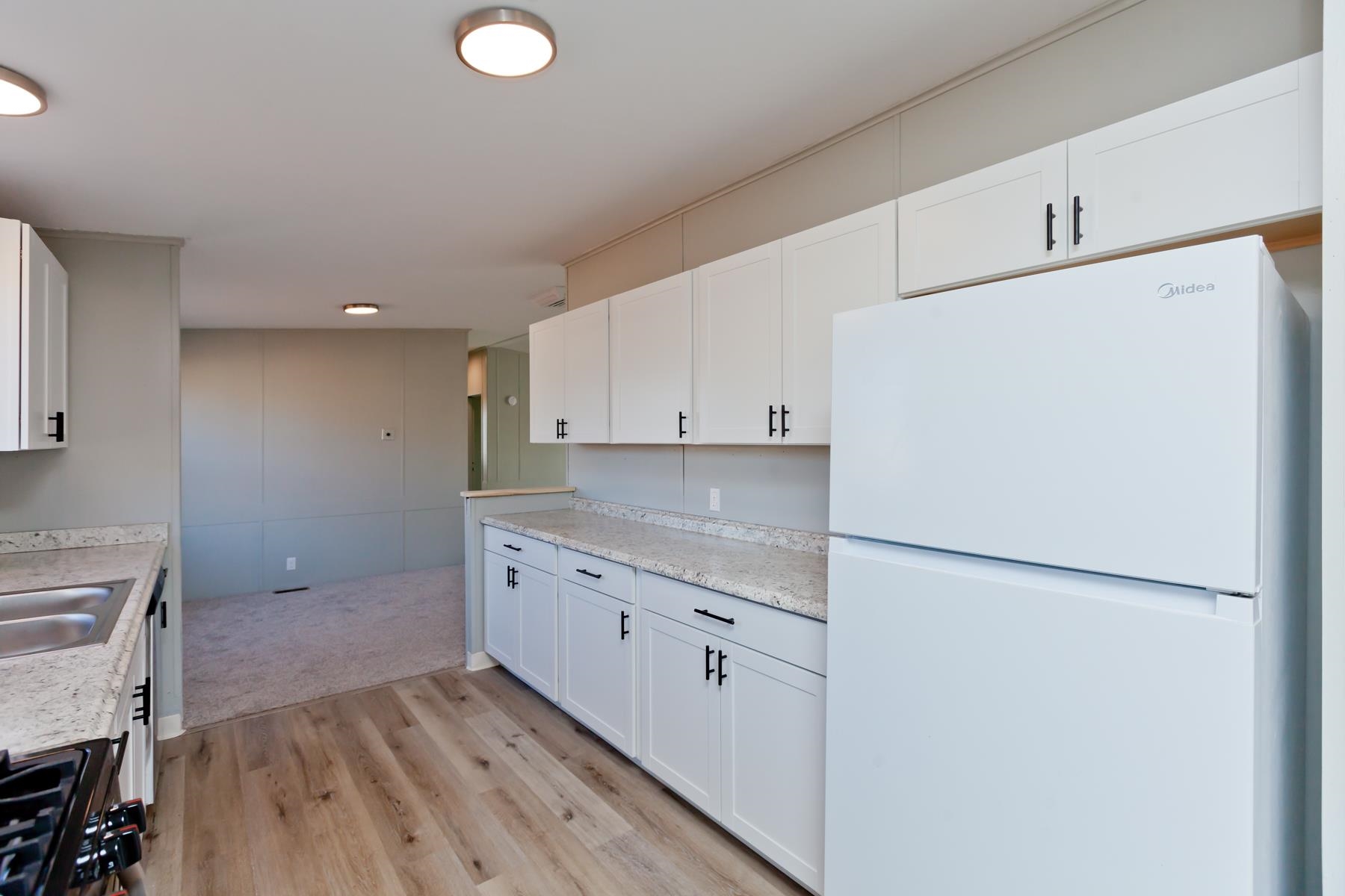3066 Cardinal Court Grand Junction, CO 81504 - Photo 10 of 41 a kitchen with a refrigerator sink stove and cabinets