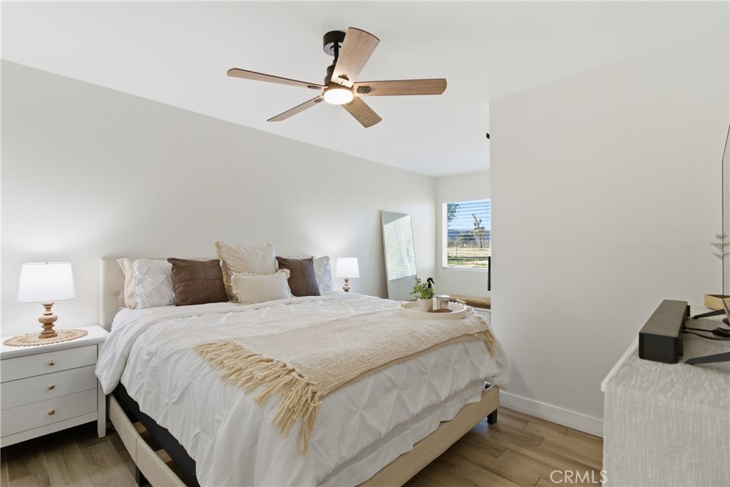 3552 Condalia Avenue Yucca Valley, CA 92284 - Photo 17 of 30 a bedroom with a bed and a chandelier