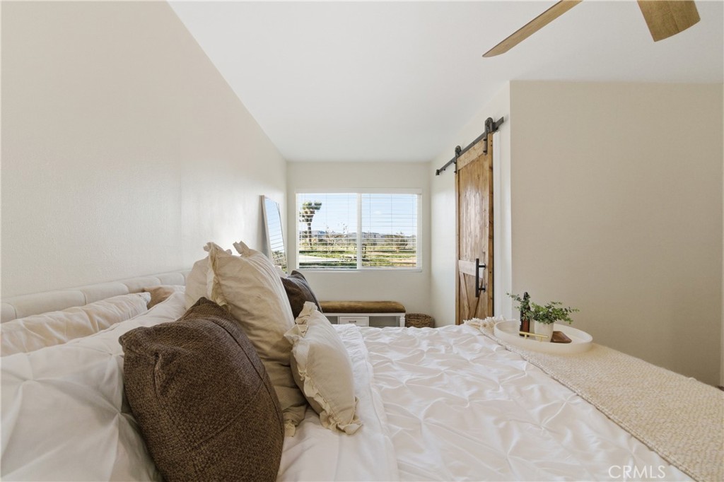 3552 Condalia Avenue Yucca Valley, CA 92284 - Photo 18 of 30 a bedroom with a large bed and a window