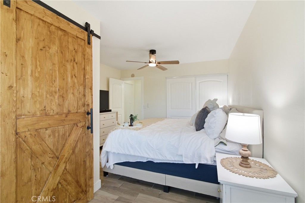 3552 Condalia Avenue Yucca Valley, CA 92284 - Photo 19 of 30 a bedroom with a bed and a chandelier