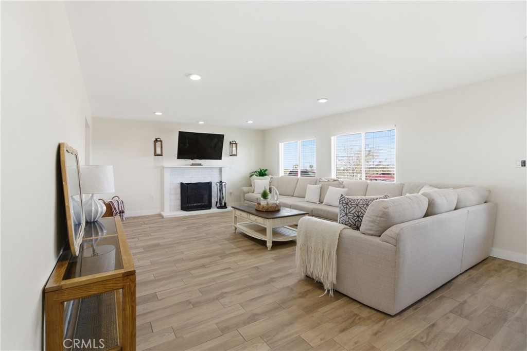 3552 Condalia Avenue Yucca Valley, CA 92284 - Photo 5 of 30 a living room with furniture a fireplace and a flat screen tv