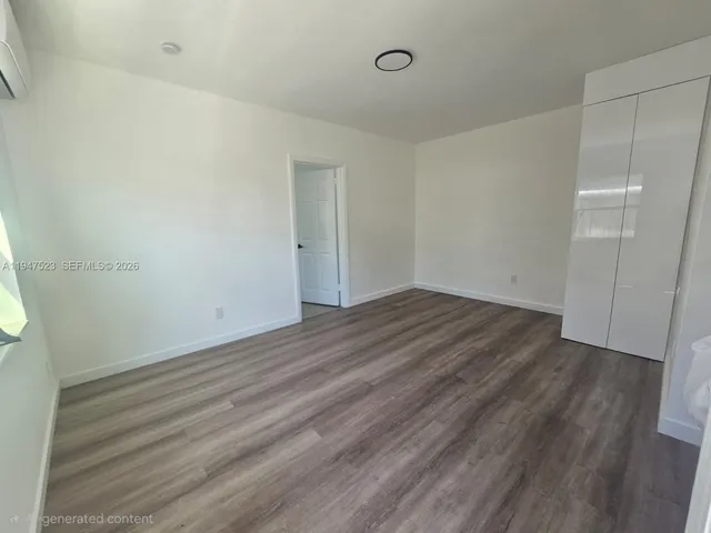 a view of a room with wooden floor