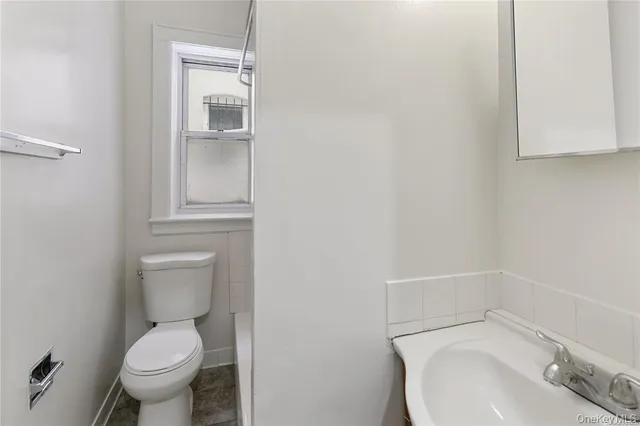 a white toilet sitting next to a bathroom sink