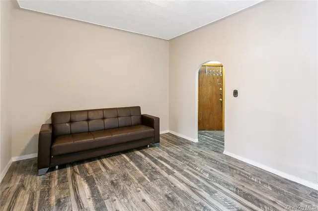 a living room with a couch and a wooden floor