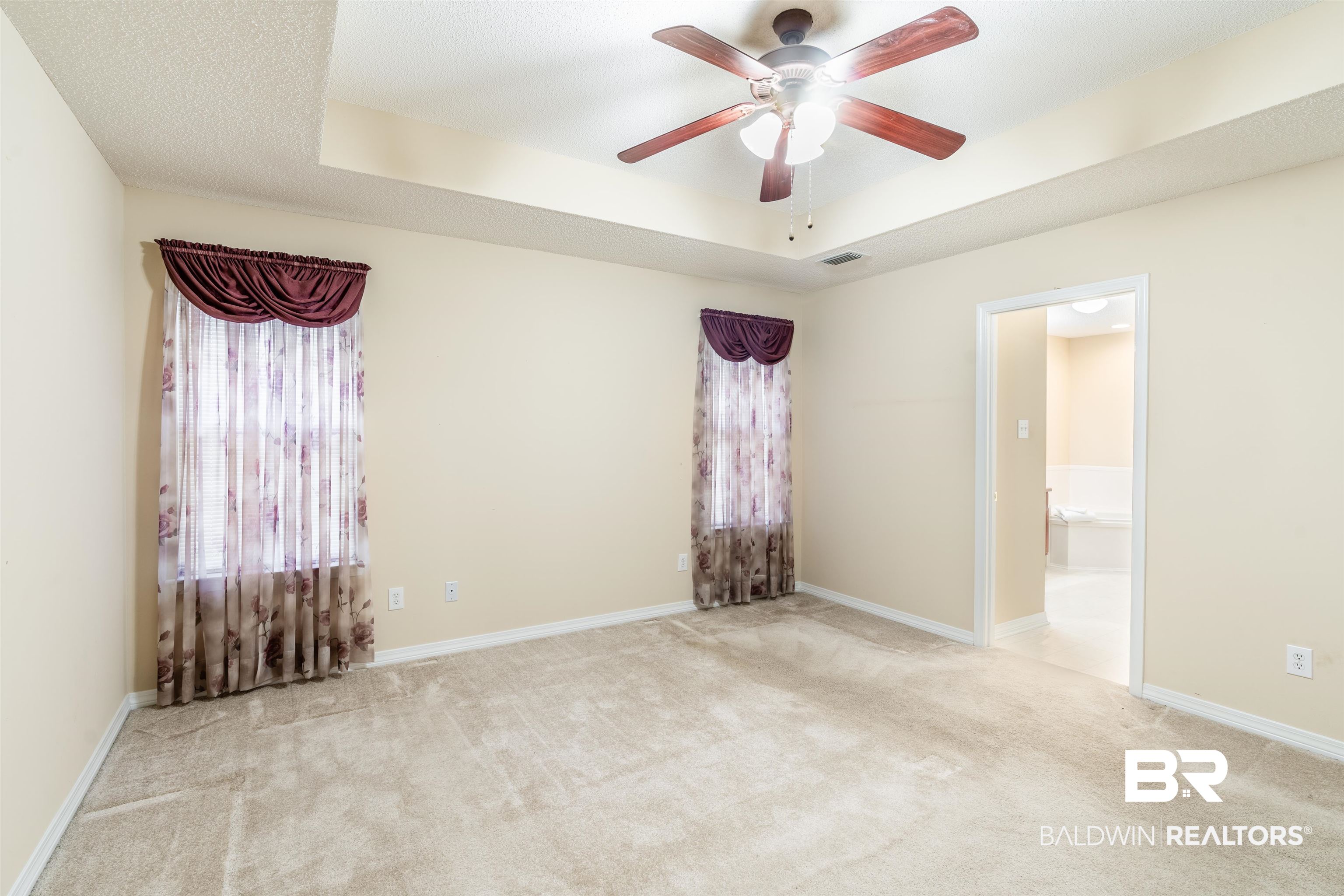 1784 Harrington Way Mobile, AL 36695 - Photo 11 of 18 Carpeted spare room with ceiling fan, a textured ceiling, and a tray ceiling