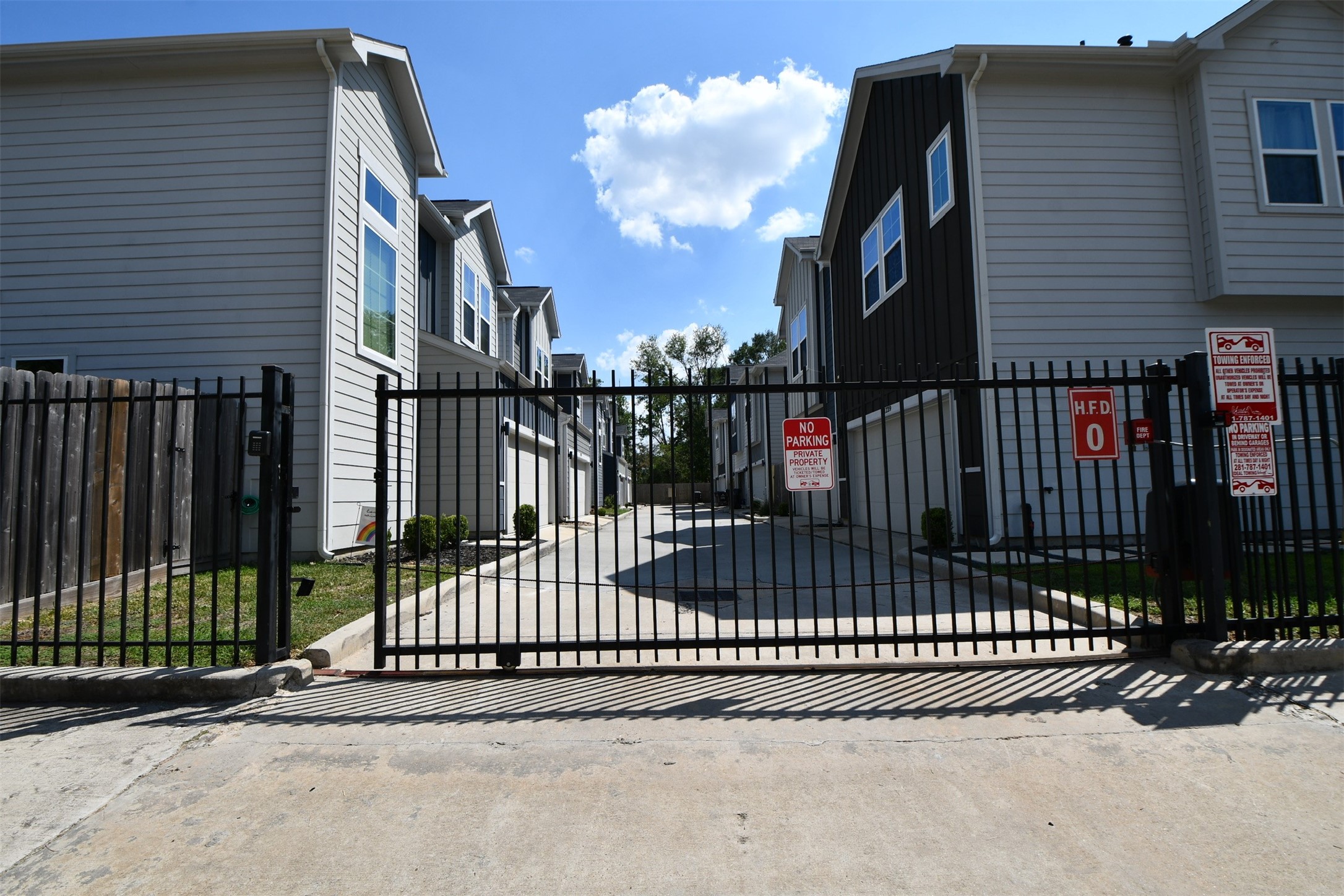 1239 West Tidwell Road Houston, TX 77091 - Photo 4 of 35 This modern townhouse features a sleek exterior with a two-car garage. The contrasting dark and light siding adds contemporary appeal. A well-maintained pathway and small lawn enhance curb appeal. Ideal for buyers seeking a stylish, low-maintenance home.