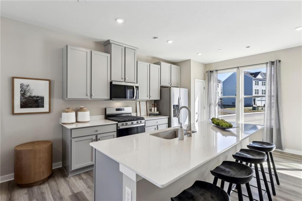 136 River Ridge Drive Coraopolis, PA 15108 - Photo 12 of 28 a kitchen with stainless steel appliances a microwave a stove a table and chairs