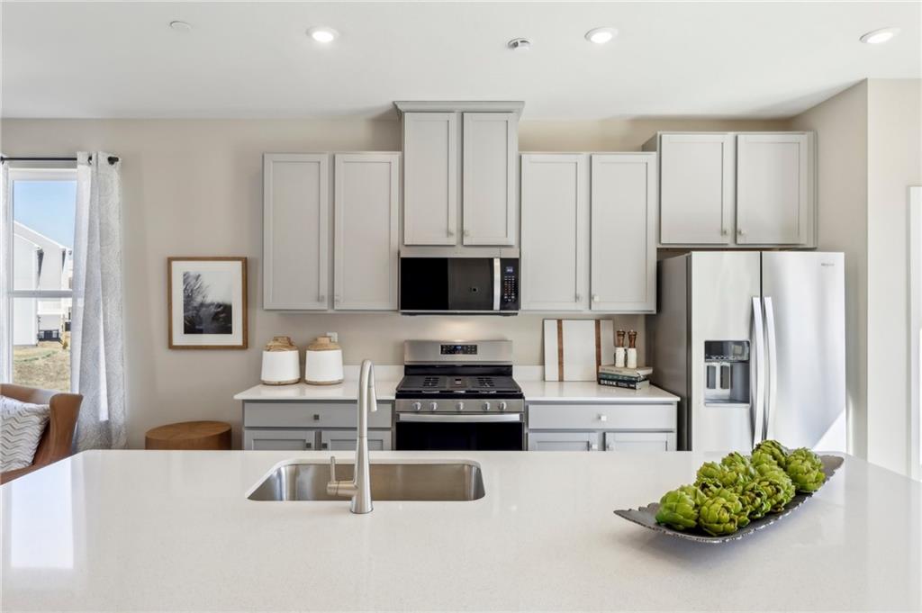 136 River Ridge Drive Coraopolis, PA 15108 - Photo 14 of 28 a kitchen with stainless steel appliances a refrigerator a stove a microwave and white cabinets