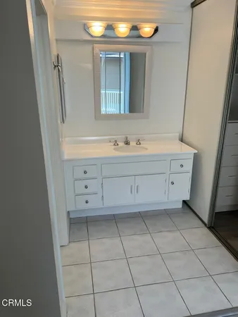 a bathroom with a bathtub sink and mirror