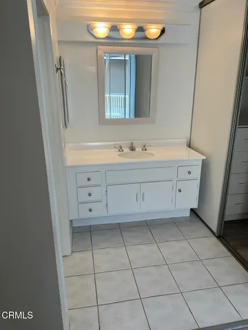a bathroom with a bathtub sink and mirror