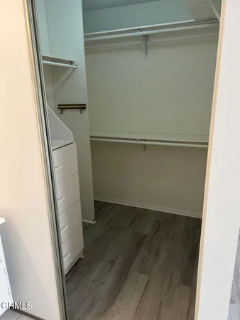 a view of walk in closet with empty racks