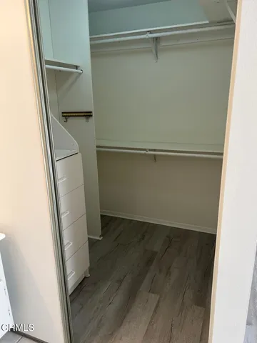 a view of walk in closet with empty racks