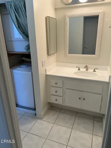 a bathroom with a double vanity sink and mirror