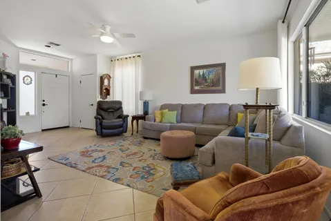 a living room with furniture and a lamp