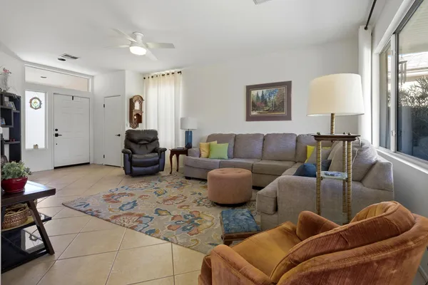 a living room with furniture and a lamp
