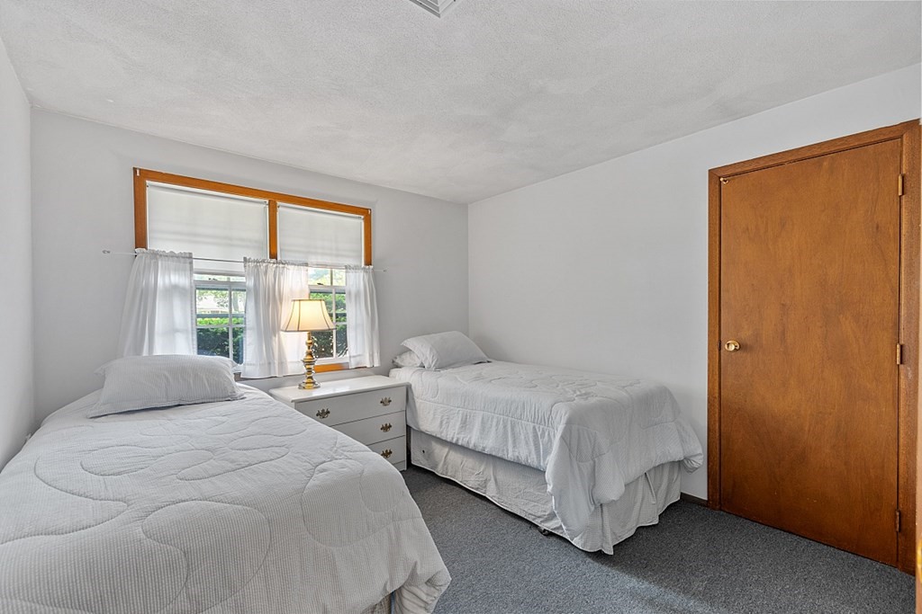 10 Bonanza Road Chelmsford, MA 01824 - Photo 16 of 41 a bedroom with two beds and a window