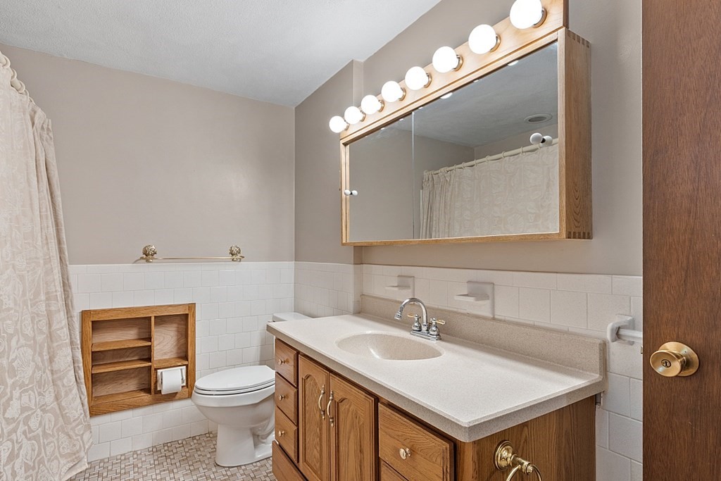 10 Bonanza Road Chelmsford, MA 01824 - Photo 19 of 41 a bathroom with a toilet sink and mirror