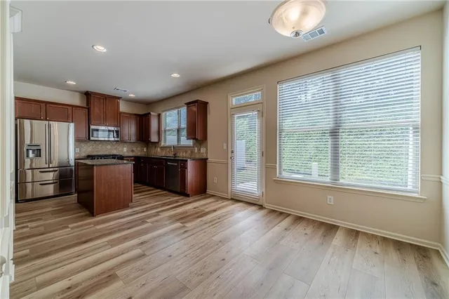 a view of a kitchen with a sink and cabinets