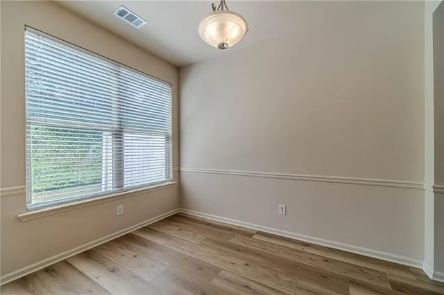 a kitchen that has a sink cabinets stainless steel appliances and a window