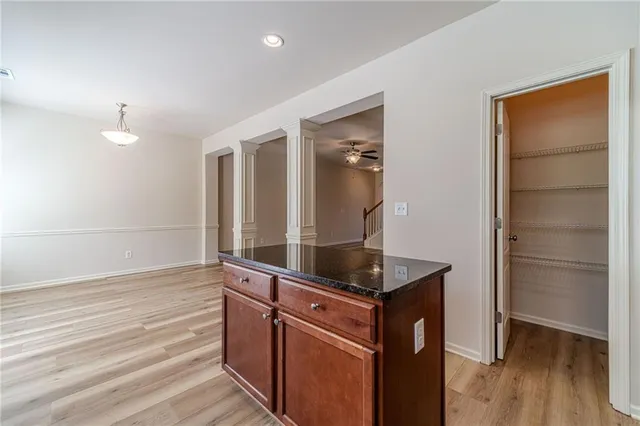a kitchen with granite countertop a sink and wooden cabinets