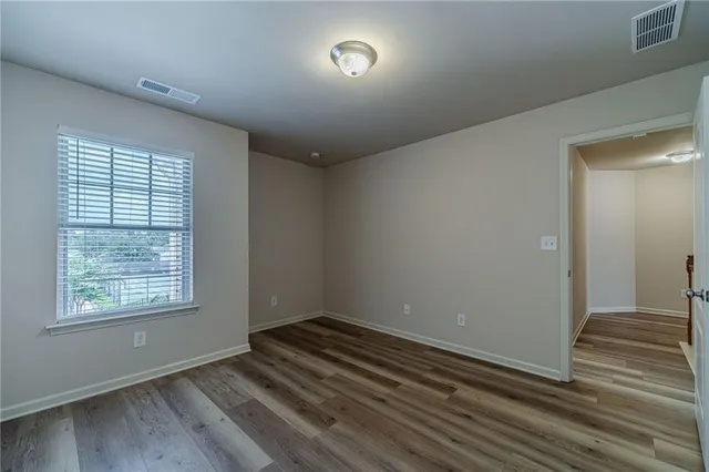 a view of a room with an empty space and wooden floor