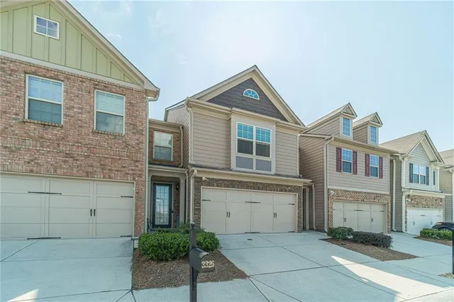 a view of a brick house with many windows