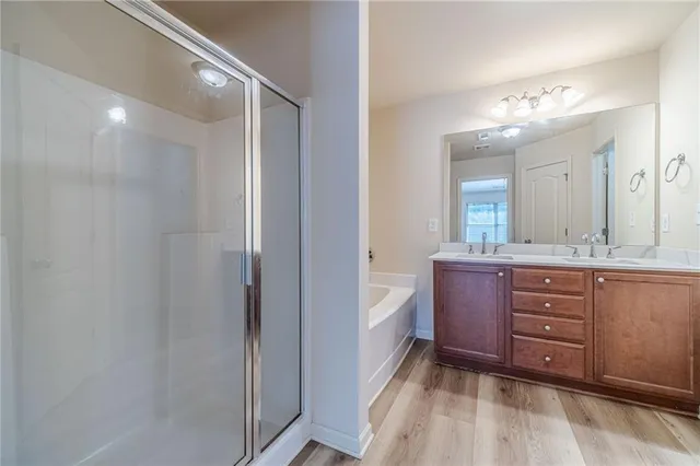 a bathroom with a tub sink and mirror